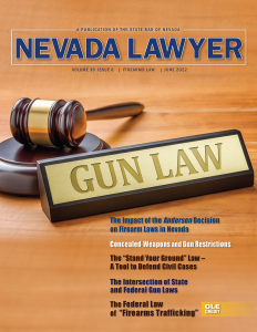 The cover of Nevada Lawyer magazine, showing a gavel and a plaque reading "Gun Law" resting on a desk.